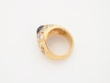 an 18k yellow gold ring set with sapphires and diamonds