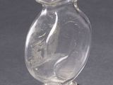 a glass vase with a fish inside of it on a table