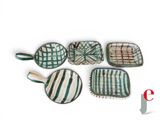 quatre pièces en céramique verte et blanche, ornées d'un motif blanc et marron