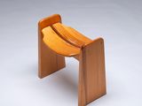 an image of a wooden bench with a curved seat