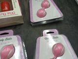 three pink plastic balls are in a package on a table