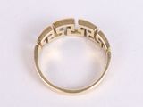 an image of a gold ring on a white surface