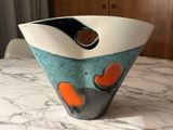 a vase that is sitting on a table with a marble surface