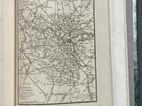 an open book on a table with a map of the city