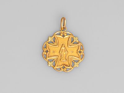 a gold pendant with a cross and a star in the center