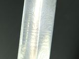 a close up of a knife with a gold handle