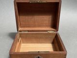 an open wooden box sitting on top of a gray surface