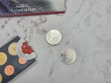 a card and a coin on a table with a book