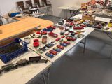 a lot of toy cars on a table in a room