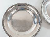 pair of silver plate with beaded rims on white background