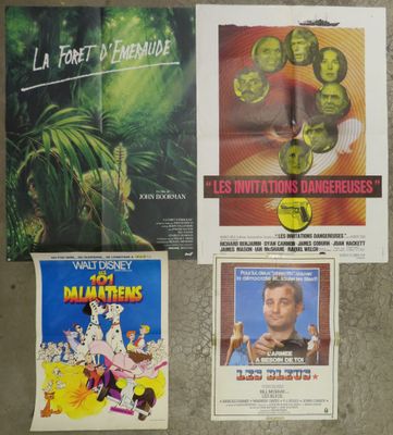 several movie posters on a wall in a room