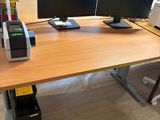 a desk with two computer monitors and a printer on it