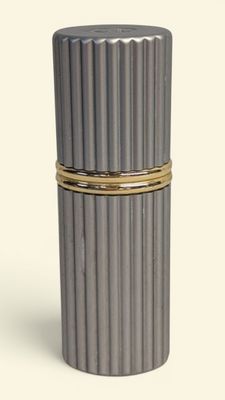 a silver container with a gold band around it