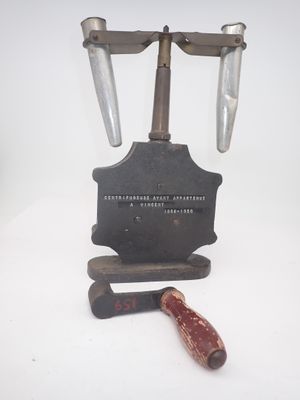 a hammer and a knife on a stand on a white surface