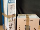 two boxes on a table with a vacuum and a cordless mop in them