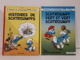 Deux livres sur les Schtroumpfs et les Schtroumpfettes sont posés sur une table