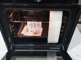 a black oven with a note taped to the door