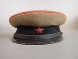 hat with a red star on it sitting on top of a table