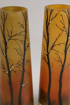 two tall vases with trees painted on them