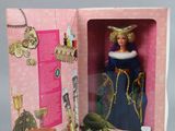 doll in a pink box with a picture of a woman in a blue dress