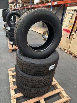 several tires are stacked on pallets in a warehouse