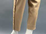 a close up of a mannequin wearing beige pants with buttons