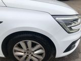 a white car parked in a parking lot with other cars in the background