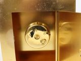 a gold clock that is sitting in the middle of a table