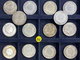 a lot of silver coins in a display case