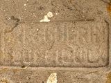 a stone plaque on the ground with a butterfly on it