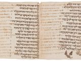 an old manuscript with writing and a bird on it
