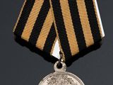 an image of a medal with a black and gold ribbon