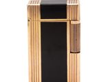 a black and gold lighter sitting on top of a white surface