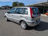 a silver van that is parked in a parking lot