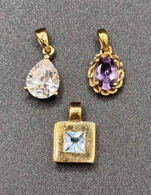 three gold and amethorate pendants