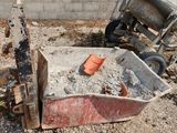 a pile of rubble next to a cement mixer and a cement mixer