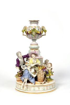a figurine of a man and a woman sitting on a table