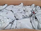 a cardboard box full of white shirts and other items