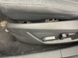 a close up of a seat in a car with the door open