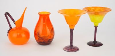 three different colored vases sitting next to each other