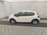 the small white car is parked in the garage
