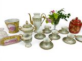 many different types of tea cups and saucers on the table