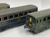 four toy train cars are lined up on a white surface