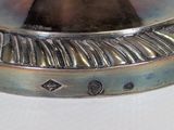 a close up of a silver plate on a table