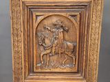 an old wooden chair with a carving of a man on a horse