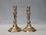 pair of antique brass candlesticks on a white background