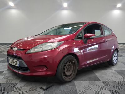 the red ford fiesta is parked in a room with a checkered floor