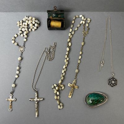 several different types of necklaces and pendants on a table