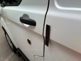 a close up of a car door handle with a sticker on it