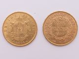 a close up of two gold coins on a white surface